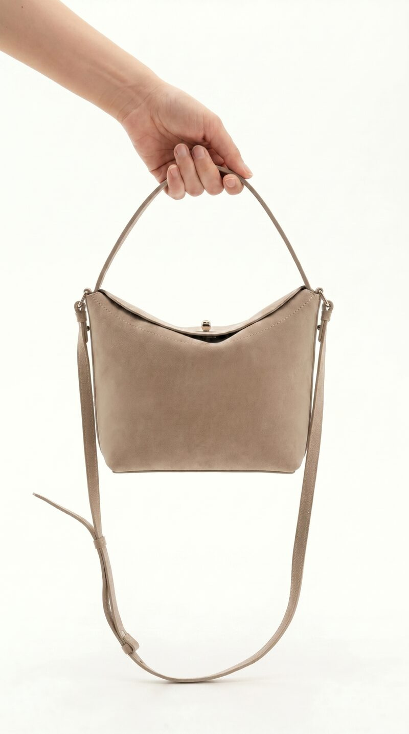 Accessories AI shoot — studio, bag held in hand